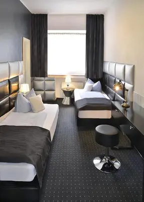 Ein Bett oder Betten in einem Zimmer der Unterkunft Hotel Am Wehrhahn