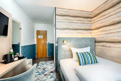 Ein Bett oder Betten in einem Zimmer der Unterkunft Home Hotel