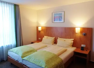 Ein Bett oder Betten in einem Zimmer der Unterkunft Hotel Mingarden