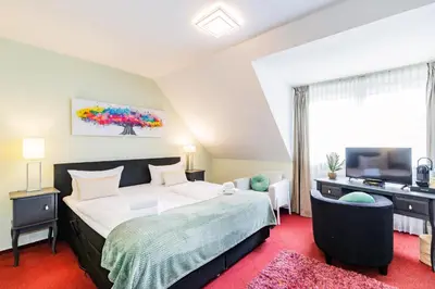 Ein Bett oder Betten in einem Zimmer der Unterkunft Hotel Fürst Garden