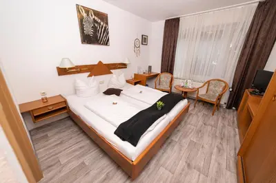 Ein Bett oder Betten in einem Zimmer der Unterkunft Hotel am Schlosspark Essen