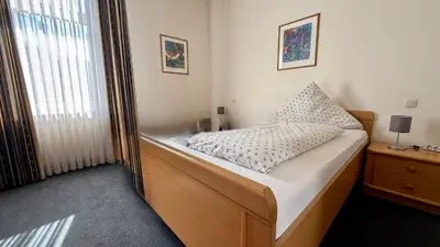 Ein Bett oder Betten in einem Zimmer der Unterkunft Hotel am Schloss Borbeck