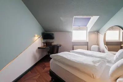 Ein Bett oder Betten in einem Zimmer der Unterkunft Hotel Haus Duden