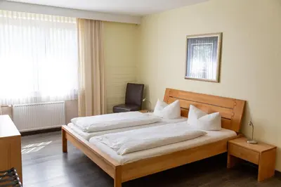 Ein Bett oder Betten in einem Zimmer der Unterkunft Hotel am Schloss Broich