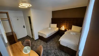 Ein Bett oder Betten in einem Zimmer der Unterkunft Hotel Rüttenscheider Stern