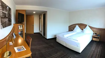 Ein Bett oder Betten in einem Zimmer der Unterkunft Ringhotel Katharinen Hof