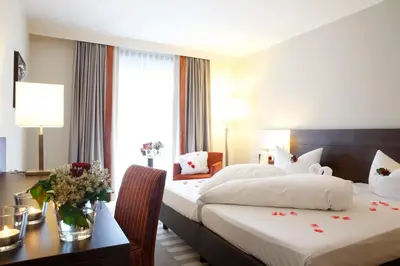 Ein Bett oder Betten in einem Zimmer der Unterkunft Parkhotel Wittekindshof