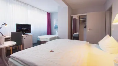 Ein Bett oder Betten in einem Zimmer der Unterkunft Excelsior Bochum