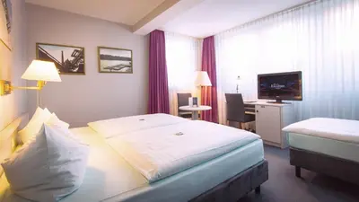 Ein Bett oder Betten in einem Zimmer der Unterkunft Excelsior Bochum