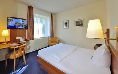 Ein Bett oder Betten in einem Zimmer der Unterkunft Hotel Haus Kronenthal