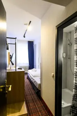 Ein Bett oder Betten in einem Zimmer der Unterkunft Hotel Ambassador Essen