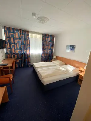 Ein Bett oder Betten in einem Zimmer der Unterkunft Hotel Dülmener Hof