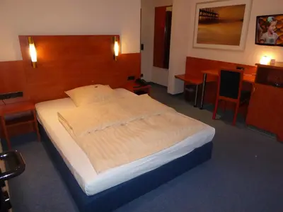 Ein Bett oder Betten in einem Zimmer der Unterkunft Astoria Hotel