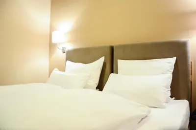 Ein Bett oder Betten in einem Zimmer der Unterkunft Langerfelder Hof