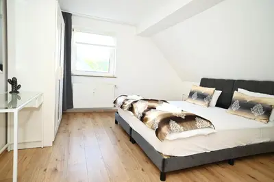 Ein Bett oder Betten in einem Zimmer der Unterkunft Ferienwohnung & Aparts am Schloss Park