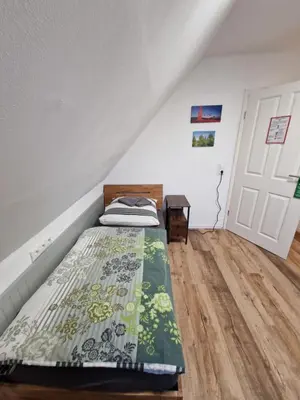 Ein Bett oder Betten in einem Zimmer der Unterkunft Pension Moers am Geleucht
